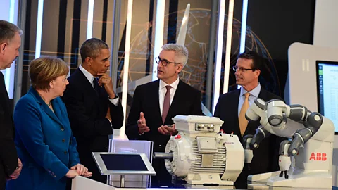 AFP/Getty Images German Chancellor Angela Merkel and US President Barack Obama meet with automation tech companies at an industrial fair in 2016. (Credit: AFP/Getty Images)