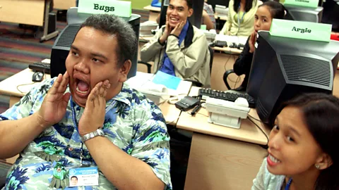 Getty Images A group of Filipino trainees undergoing a speech exercise at an English language course in Manila in 2006 (Credit: Getty Images)