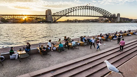 Manfred Gottschalk/Getty Images At dinner in Sydney the bill is often split evenly regardless of differences in wealth (Credit: Manfred Gottschalk/Getty Images)