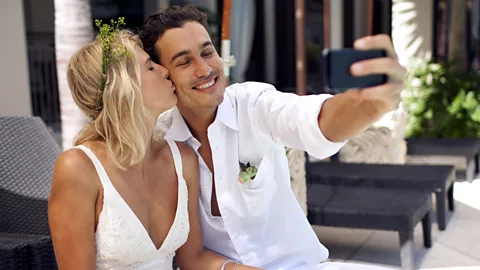Getty Images Smiling newlyweds taking a selfie (Credit: Getty Images)