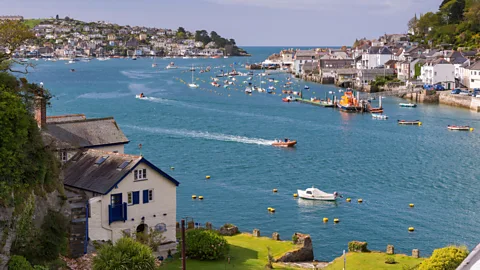 Alamy Du Maurier’s family home Ferryside, on the left, was in the Cornwall village of Bodinnick, right on the Fowey Estuary – the setting of many of her stories (Credit: Alamy)