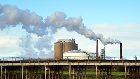 A factory with smoking chimneys