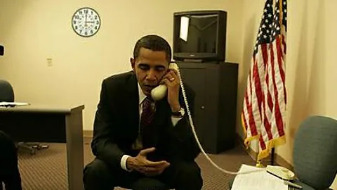 Snopes This photo of Barack Obama circulated in 2008, but is fake - the clock is a clue, a reference to a Hillary Clinton TV ad about picking up the phone at 3:00 (Credit: Snopes)