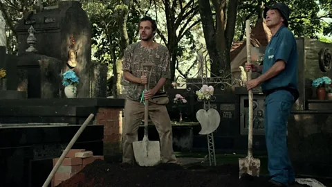 Filmes do Caixote/ Vitrine Filmes Many Brazilian horror films are deeply rooted in local environs, such as The Necropolis Symphony, a musical about a gravedigger (Credit: Filmes do Caixote/ Vitrine Filmes)