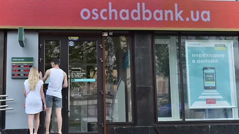 Sergei Supinsky/AFP/Getty Images Oschadbank, one of the largest banks in Ukraine, was forced to shut its branches (Credit: Sergei Supinsky/AFP/Getty Images)