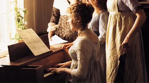 Alamy As this scene in the 1995 film Sense and Sensibility illustrates, it wouldn't be a Jane Austen movie without a young woman at a piano (Credit: Alamy)