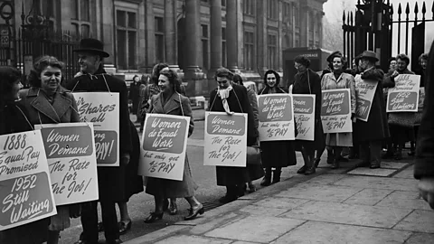 Evening Standard/Getty Images A protest by UK civil servants in the mid 20th Century. One sign reads: '1888 equal pay promised; 1952 still waiting' (Credit: Evening Standard/Getty Images)