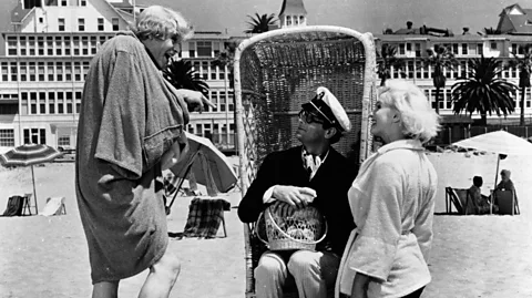Alamy Stealing his accent from Cary Grant, Joe styles himself as Junior, heir to the Shell Oil fortune, in order to woo Sugar (Monroe) (Credit: Alamy)