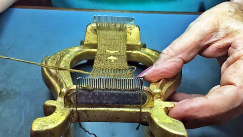 Eliot Stein Chiara Vigo uses her fingernails and a nail to embroider a small piece of sea silk cloth (Credit: Eliot Stein)