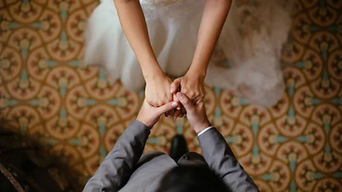iStock Newlyweds holding hands (Credit: iStock)