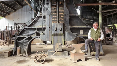 Chris Griffiths Older man posing in front of furnace (Credit: Chris Griffiths)