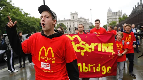 Getty Images Demonstrators protest working conditions and zero-hour contracts in central London on 4 September (Credit: Getty Images)
