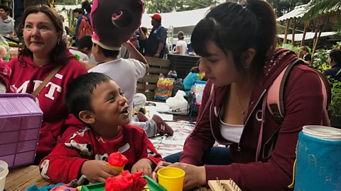 Julissa Trevino Karla Martínez, a pedagogy student at UNAM, plays with a Isaac, 4, at a shelter in Colonia Roma (Credit: Julissa Trevino)