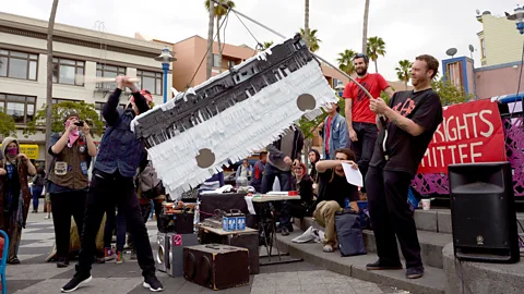 Alamy Protesters attack a Google bus piñata in in San Francisco in 2013 (Credit: Alamy)