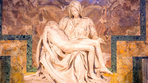 Michelangelo's Pieta statue in St. Peter's Basilica in Rome depicting Mary holding Christ after the crucifixion