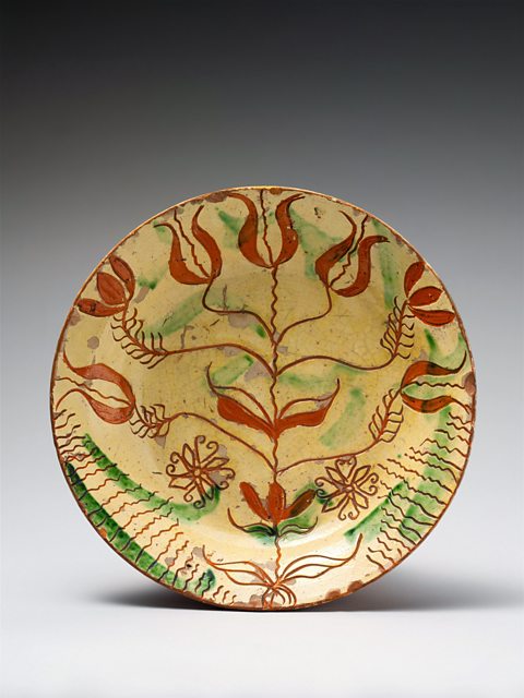 Yellow plate with a red floral pattern and green streaks