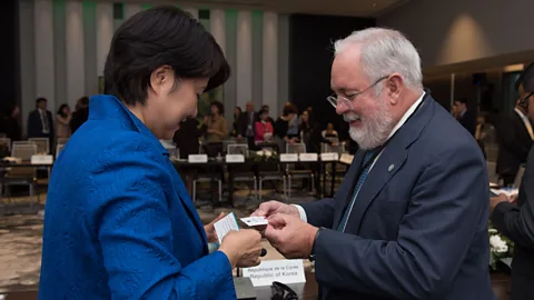 Getty Images EU climate official Miguel Arias Canete exchanges business cards with Japan's State Minister of the Environment Naomi Tokashiki (Credit: Getty Images)