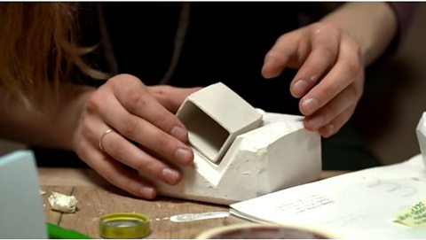 slip cast object being removed from mould