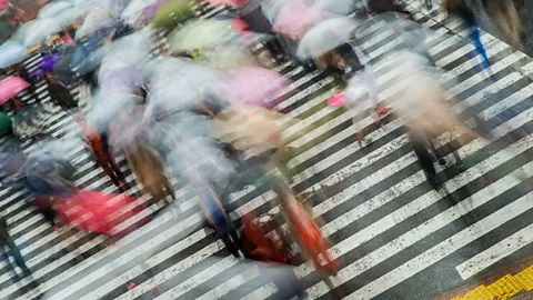 Alamy Japanese pedestrians in rain (Credit: Alamy)