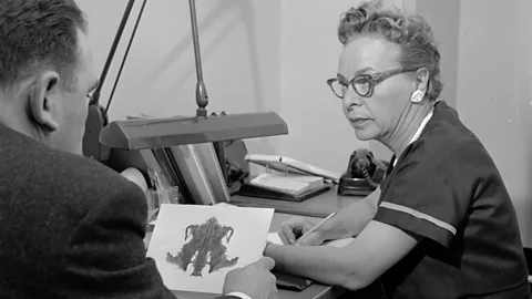 Getty Images A psychologist discusses a patient's interpretation of an inkblot, a psychoanalytical method known as a Rorschach test (Credit: Getty Images)