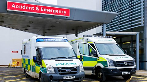 Ambulances outside a hospital. Hospitals operate in the public sector