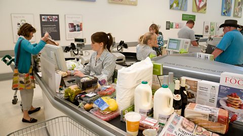 A supermarket checkout.Supermarkets operate in the private sector