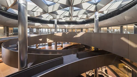 Nigel Young/Foster + Partners The centrepiece is a spiralling ramp spanning six floors in a triple-helix formation, designed as a place of meeting (Credit: Nigel Young/Foster + Partners)