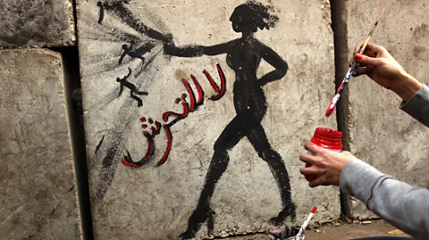 Getty Images Graffiti reading 'no to sexual harassment' in Arabic on a wall outside the presidential palace in Cairo (Credit: Getty Images)