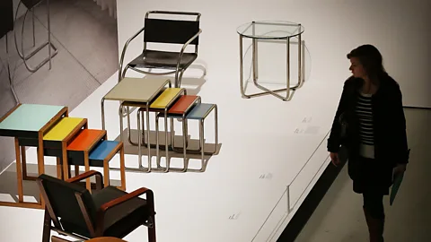Fred Duval/WireImage A visitor looks at tables and chairs on display at the 'Bauhaus Art as Life' exhibition in London, 2012 (Credit: Fred Duval/WireImage)