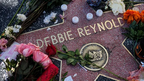Alamy There was a massive outpouring of public grief over Reynolds and Fisher’s deaths in 2016, including at their stars on the Hollywood Walk of Fame (Credit: Alamy)