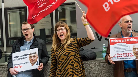 Alamy Live News Hotel workers in London last year protesting for mandatory rules on tipping in hotels and restaurants so that the staff get 100% of all tips (Credit: Alamy Live News)