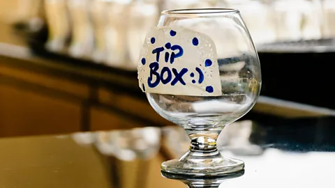 Alamy In many countries, bartenders and servers at restaurants depend on tips to earn a livable wage (Credit: Alamy)