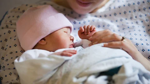 Alamy Woman holding newborn baby (Credit: Alamy)