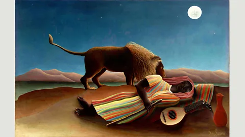Alamy In Henri Rousseau’s Sleeping Gypsy (1897), a moonlit lion sniffs a figure sleeping beside a mandolin (Credit: Alamy)