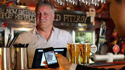 Getty Images Using a smartphone and a QR code scanning application customers can pay at the bar. The Old Fitzroy was the first Australian pub to accept Bitcoin payment (Credit: Getty Images)