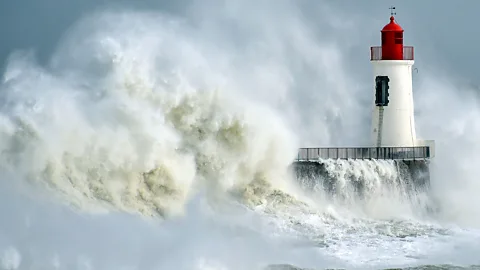 Getty Images Waves pounding lighthouse (Credit: Getty Images)