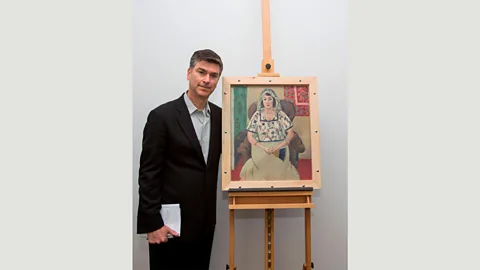 Alamy One of the most significant finds was Seated Woman by Matisse – owned by the Jewish art dealer Paul Rosenberg – seen here with a Rosenberg representative (Credit: Alamy)