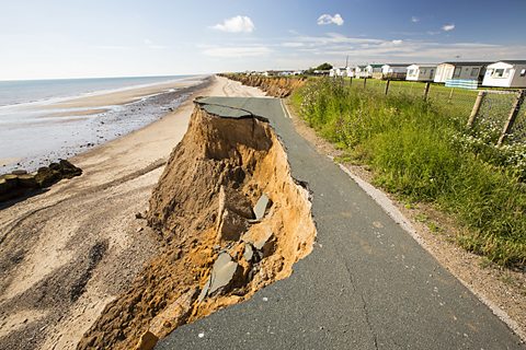 A collapsed coastal road between Yorkshire’s East Coast. To the right of the road is a row of static homes.