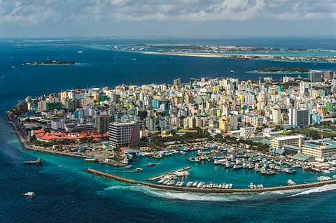 Aerial view of Malé, the capital city of the Maldives. Surrounding the city is a huge concrete sea belt which provides protection from the sea.