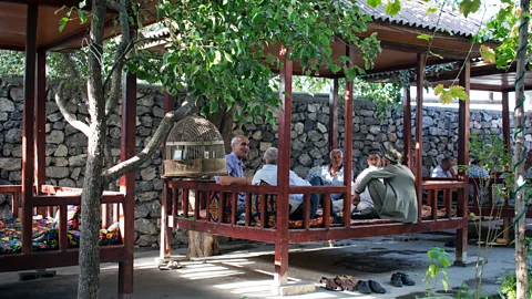 Amanda Ruggeri Men eating oshi palav at a teahouse in Tajikistan (Credit: Amanda Ruggeri)