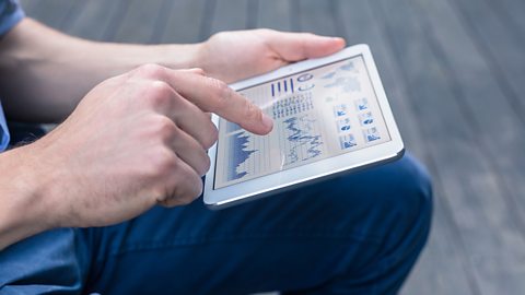 Close up of hands using a tablet computer