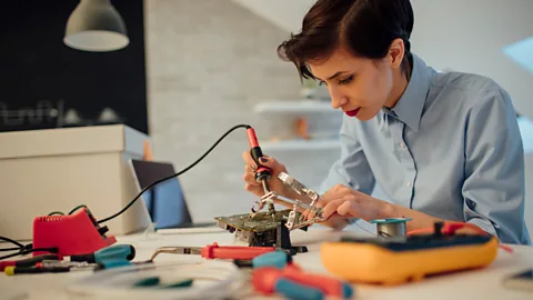 Woman working on circuit board