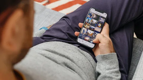 Getty Images Man browses phone (Credit: Getty Images)