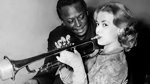Getty Black jazz musicians like Miles Davis – shown here with the actress Jeanne Moreau – flocked to Paris, where the art form received its due (Credit: Getty)