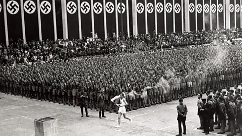 Getty Images The relay of the Olympic flame from Olympia, Greece, to the host city began in 1936 – Hitler wanted to use the games to connect his Reich with ancient might (Credit: Getty Images)