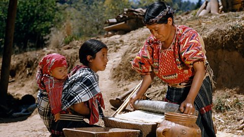 A Maya woman grinding corn