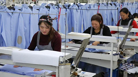 STR/AFP/Getty Images Female labour rates in China have steadily dropped since the 1970s (Credit: Getty Images)