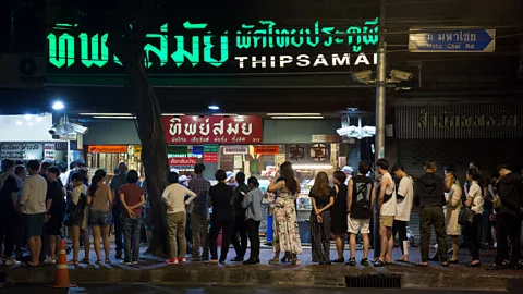 Alisa Suwanrumpha People queue at Thipsamai Pad Thai well before the restaurant opens (Credit: Alisa Suwanrumpha)