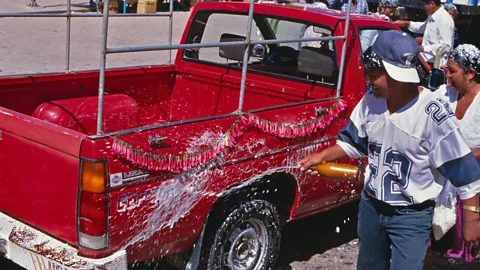 Margie Politzer/Getty Images A car is blessed with beer in Copacabana, Bolivia (Credit: Margie Politzer/Getty Images)