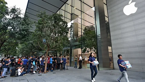 ROSLAN RAHMAN/Getty Images Singaporeans will queue endlessly for the latest model of a phone (Credit: ROSLAN RAHMAN/Getty Images)